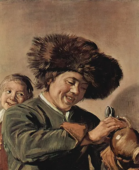 Two laughing boys with mug of beer