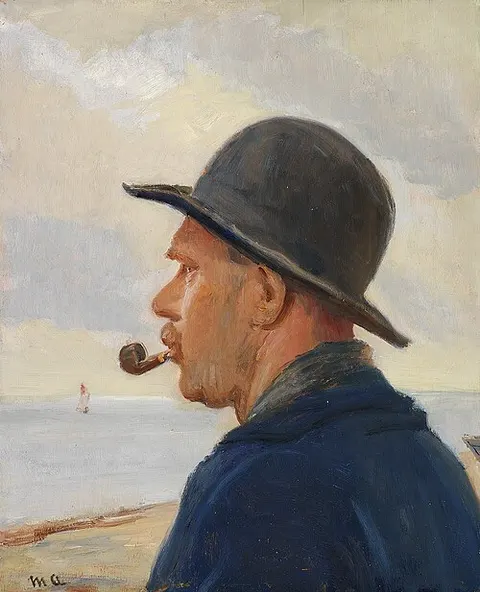 A man with pipe and a felt hat on the Skagen beach.
