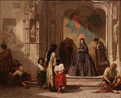 Young woman doing charity at the entrance to the chapel of San Sebastián Hospital in Cordoba