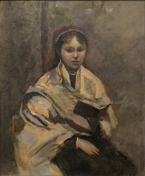 Sitting young girl with a book in her hand