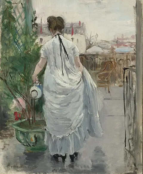 Young Woman Watering a Shrub